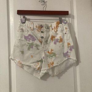 distressed white color splash jean shorts.